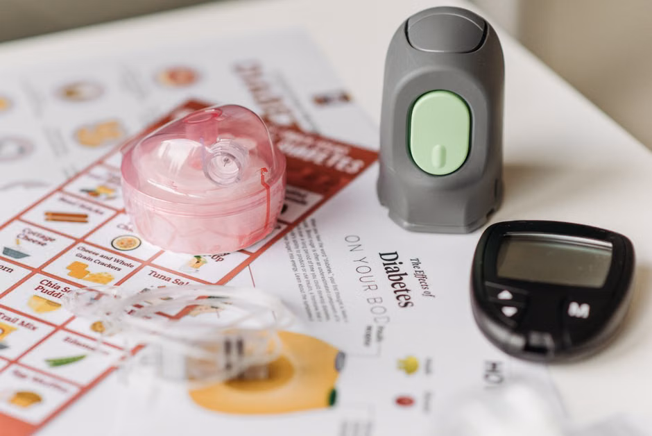 Close-up of blood sugar monitoring devices and educational materials for diabetes care.